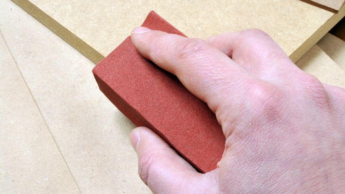 Using a sandpaper sponge to smoothen the surface 