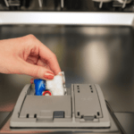 dishwasher tablet being placed into a dishwasher