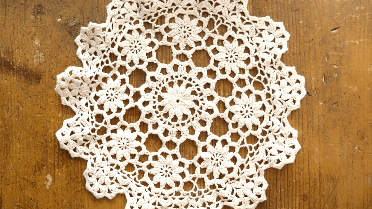white crochet doily on table